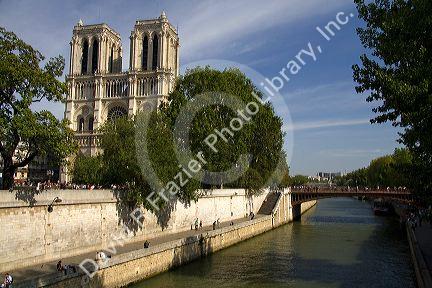 The western facade of the Notre Dame de Paris along the river Seine in Paris, France.