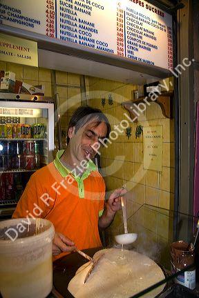 French man working at a Creperie in the Latin Quarter of Paris, France.