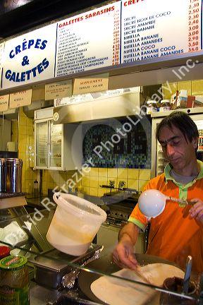 French man working at a Creperie in the Latin Quarter of Paris, France.