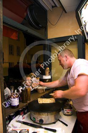 French man making crepes at a Creperie in the Montmartre District of Paris, France.