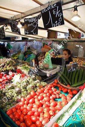 People shopping for produce at an outdoor Saturday market in Paris, France.