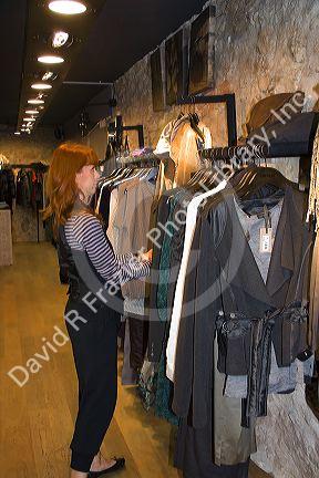Woman shopping for clothing at a store in Nancy, France.