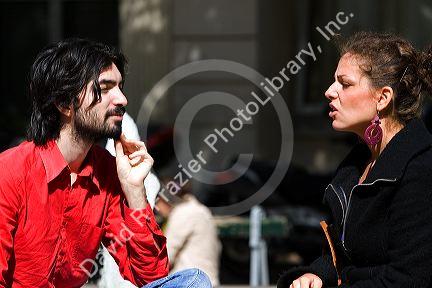 French man and woman have a conversation near the Sorbonne in Paris, France.