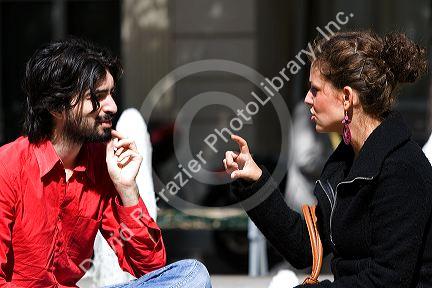 French man and woman have a conversation near the Sorbonne in Paris, France.