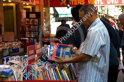 Customers shopping at a bookstore along Boulevard Saint-Michel in the Latin Quarter of Paris, France.
