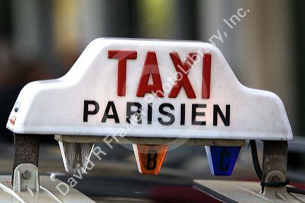 Sign atop a taxicab in Paris, France.
