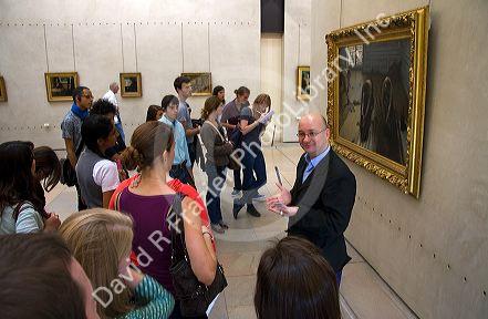 Visitors view artwork displayed in the Musee d'Orsay, Paris, France.