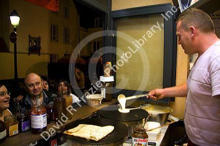 French man making crepes at a Creperie in the Montmartre District of Paris, France.