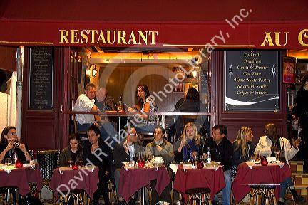 Restaurant exterior and nightlife in the Montmartre District of Paris, France.