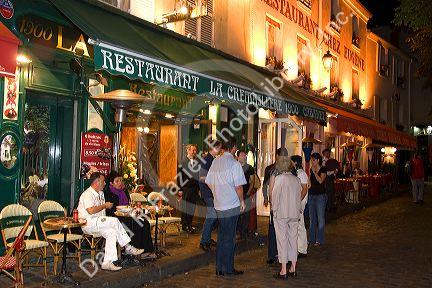 Restaurant exterior and nightlife in the Montmartre District of Paris, France.
