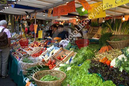 People shopping for produce at an outdoor Saturday market in Paris, France.