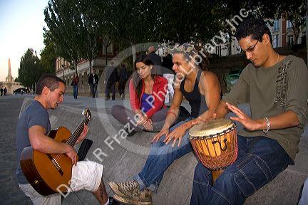 Young parisiens play music along the River Seine in Paris, France.