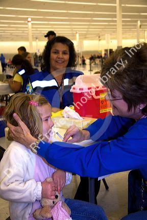 Health care professional administering the nasal spray H1N1 influenza vaccine to a child in Boise, Idaho.