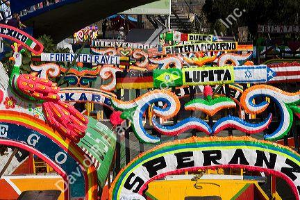 Colorful trajineras travel on the Xochimilco canals within Mexico City, Mexico.