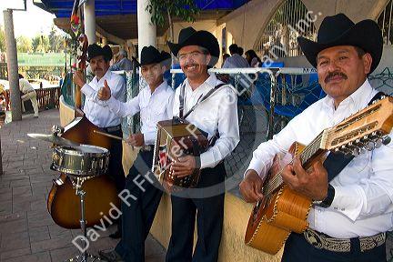 Mariachi band performing along the Xochimilco canals within Mexico City, Mexico.