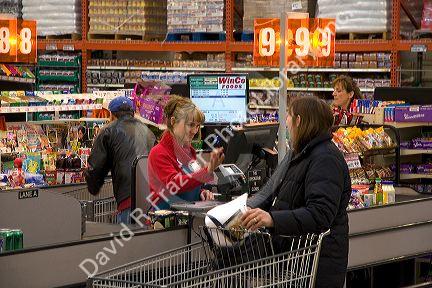 Customer and cashier in the checkout line of a supermarket in Idaho, USA.