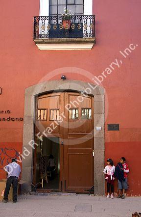 Children stand at the entrance to a private school in the city of Puebla, Puebla, Mexico.