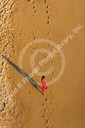 Person walking on the beach at Acapulco, Guerrero, Mexico.