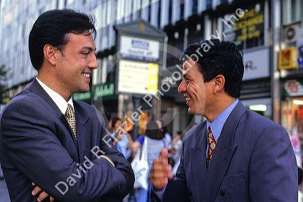 Chilean businessmen talk on the street in Santiago, Chile.