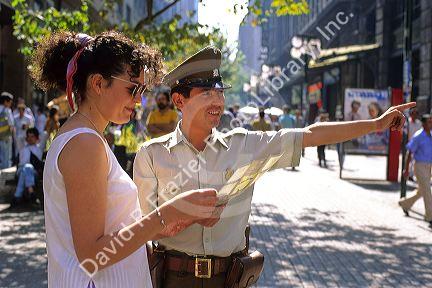 Chilean police officer giving a woman directions in Santiago, Chile.