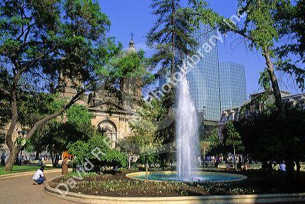 Water fountain and the Metropolitana Cathedral in the Plaza de Armas, Santiago, Chile.