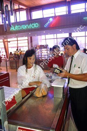 Teenage girl working in a supermarket in Chile.