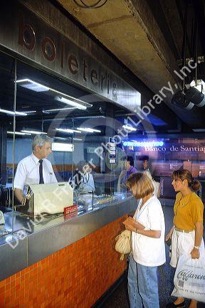 Passengers purchase tickets to the Metro in Santiago, Chile.