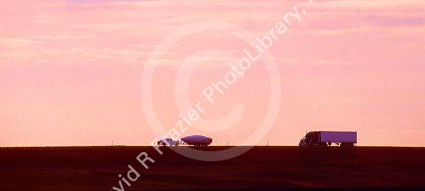 Traffic silhouetted on Interstate 70 west of Limon, Colorado.
