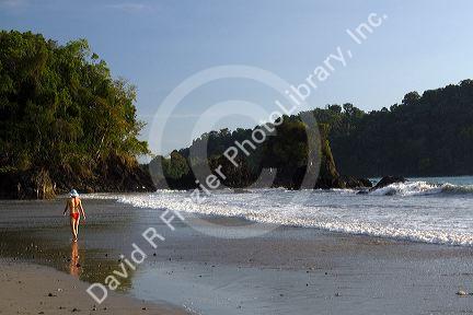 Woman walking on the beach at Manuel Antonio National Park in Puntarenas province, Costa Rica.