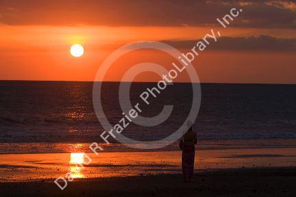 Person walking on the beach at sunset in the Manuel Antonio National Park in Puntarenas province, Costa Rica.