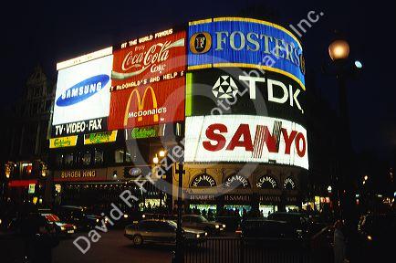 Large electronic signs on the sides of buildings in Piccadilly Circus, London, England.