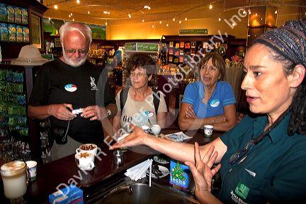 Barista making coffee drinks with tourists at the Britt coffee bar in San Rafael de Heredia, Costa Rica.