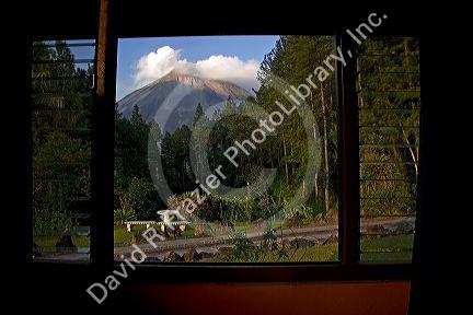 View of the Arenal Volcano from a window of the Arenal Observatory Lodge near La Fortuna, San Carlos, Costa Rica.
