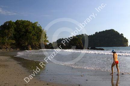 Woman walking on the beach at Manuel Antonio National Park in Puntarenas province, Costa Rica.