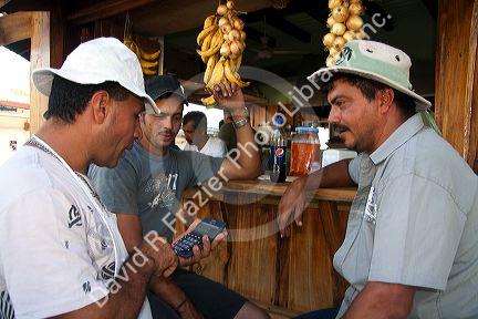 Server and customers at an outdoor cafe in Quepos, Costa Rica.
