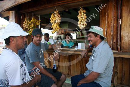 Server and customers at an outdoor cafe in Quepos, Costa Rica.