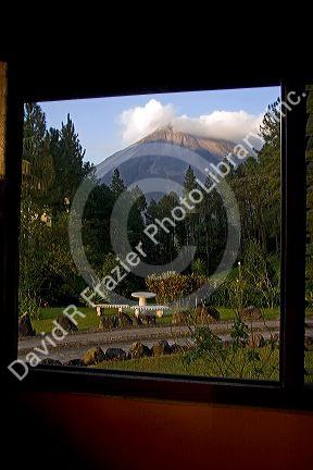 View of the Arenal Volcano from a window of the Arenal Observatory Lodge near La Fortuna, San Carlos, Costa Rica.