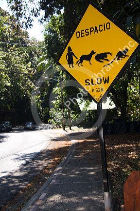 Road sign warning of people and animal crossing at the Manuel Antonio National Park in Puntarenas province, Costa Rica.