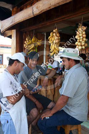 Server and customers at an outdoor cafe in Quepos, Costa Rica.