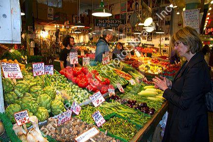 Vendor selling produce at the Pike Place Market in Seattle, Washington, USA.