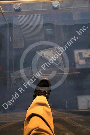 A man's foot on the skydeck of the Willis Tower in Chicago, Illinois, USA.