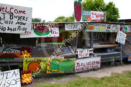 Colorful signage of a roadside produce stand along Highway 60 near Brandon, Florida, USA.
