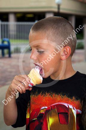 6 year old boy eating an ice cream cone in Brandon, Florida, USA. MR