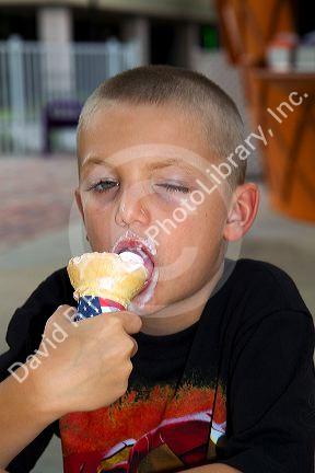 6 year old boy eating an ice cream cone in Brandon, Florida, USA. MR
