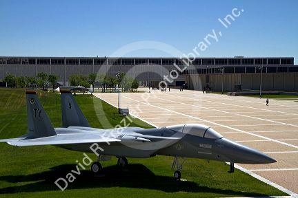 F-15 aircraft on display in the Terrazzo with dormitories in the background at the Air Force Academy in Colorado Springs, Colorado, USA.