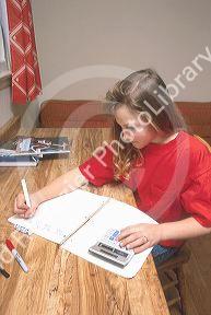 Young girl using a solar calculator.