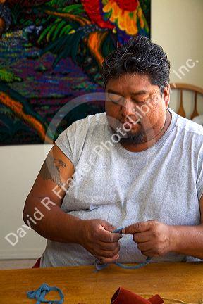 Native Pueblo man crafting a dreamcatcher in San Felipe Pueblo, New Mexico, USA.