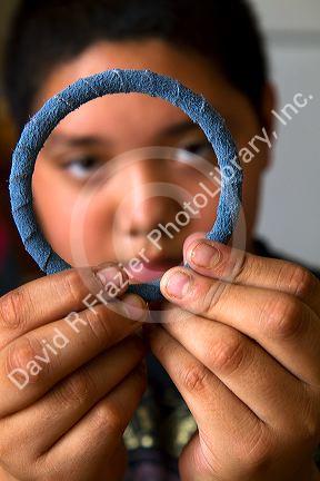 Native Pueblo boy crafting dreamcatchers in San Felipe Pueblo, New Mexico, USA.