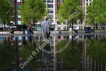 The illusion of a man walking on water is in the black granite reflecting pool of the Crown Fountain in Millennium Park, Chicago, Illinois, USA. MR