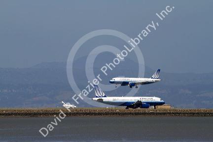 Airliners land and take off from San Francisco International Airport, California, USA.